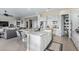 Kitchen features a large island, white cabinets, stainless steel appliances, and tile flooring at 5189 N 206Th Dr, Buckeye, AZ 85396
