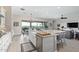 Kitchen with large island, granite countertops, stainless steel appliances, and adjacent living spaces at 5189 N 206Th Dr, Buckeye, AZ 85396