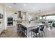 Kitchen with large island, granite countertops, breakfast bar, and stainless steel appliances at 5189 N 206Th Dr, Buckeye, AZ 85396