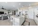 Kitchen features a large island, white cabinets, stainless steel appliances, and tile flooring at 5189 N 206Th Dr, Buckeye, AZ 85396