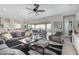 Open-concept living room with a ceiling fan and seamless indoor-outdoor flow at 5189 N 206Th Dr, Buckeye, AZ 85396