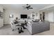 Spacious living room featuring a ceiling fan and built-in shelving at 5189 N 206Th Dr, Buckeye, AZ 85396