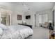Relaxing main bedroom with ceiling fan, accent chairs, and a mounted tv at 5189 N 206Th Dr, Buckeye, AZ 85396