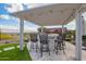 Outdoor bar beneath a pergola features seating for six and views of the community at 5189 N 206Th Dr, Buckeye, AZ 85396