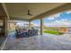 Covered patio with a ceiling fan and outdoor seating area, with beautiful views of the backyard at 5189 N 206Th Dr, Buckeye, AZ 85396