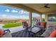 Serene covered patio featuring comfortable seating, a ceiling fan, and stunning backyard vistas at 5189 N 206Th Dr, Buckeye, AZ 85396