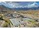 Aerial view of pickleball courts surrounded by desert landscape and scenic mountain backdrop at 5189 N 206Th Dr, Buckeye, AZ 85396