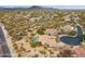 Aerial shot of a desert community highlighting home with a pool and mature landscaping, showcasing community layout at 5210 E Calle De Baca --, Cave Creek, AZ 85331