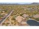 Aerial view of a home with desert landscaping, a pool, and a circular driveway, showcasing the property's layout at 5210 E Calle De Baca --, Cave Creek, AZ 85331