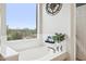 Relaxing bathroom showcasing a garden tub with a decorative wall hanging and serene backyard view at 5210 E Calle De Baca --, Cave Creek, AZ 85331