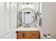 Stylish bathroom featuring a modern vanity, round mirror, and chic wall lighting at 5210 E Calle De Baca --, Cave Creek, AZ 85331