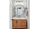 Stylish bathroom with a modern round mirror, wood vanity, and neutral color scheme at 5210 E Calle De Baca --, Cave Creek, AZ 85331