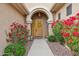 Inviting front door with vibrant floral landscaping creating a warm welcome at 5210 E Calle De Baca --, Cave Creek, AZ 85331