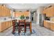 Open kitchen dining area featuring ample cabinetry, stainless appliances, and hardwood dining set at 5210 E Calle De Baca --, Cave Creek, AZ 85331