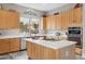 Bright kitchen featuring light wood cabinets, white countertops, and a convenient center island at 5210 E Calle De Baca --, Cave Creek, AZ 85331