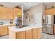 Modern kitchen featuring a center island with cooktop and oven, stainless steel refrigerator, and ample cabinet storage at 5210 E Calle De Baca --, Cave Creek, AZ 85331