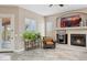 Comfortable seating area with fireplace, TV, and view of the outdoors through large windows at 5210 E Calle De Baca --, Cave Creek, AZ 85331
