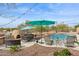 Outdoor patio space with a BBQ, pizza oven, dining, and lounge seating next to freeform pool at 5210 E Calle De Baca --, Cave Creek, AZ 85331