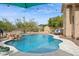Resort-style pool with rock waterfall, mature desert landscaping, and chaise lounges for relaxing by the water at 5210 E Calle De Baca --, Cave Creek, AZ 85331