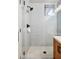 Bathroom shower featuring mosaic tile floor, glass door, and light tiling in shower at 5210 E Calle De Baca --, Cave Creek, AZ 85331