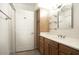 Bathroom featuring modern vanity with storage, a large mirror, and stylish lighting fixtures at 5303 N 7Th St # 101, Phoenix, AZ 85014