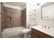 This bathroom has decorative tile, a shower-tub, and a matching vanity at 5303 N 7Th St # 101, Phoenix, AZ 85014
