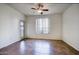 Bright bedroom with tile floors, ceiling fan, and sliding glass door leading to private patio at 5303 N 7Th St # 101, Phoenix, AZ 85014