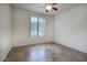 This bright bedroom has tile floors, a ceiling fan, and a large window at 5303 N 7Th St # 101, Phoenix, AZ 85014