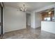 Dining area with modern chandelier, tile floors, and open access to the kitchen and living spaces at 5303 N 7Th St # 101, Phoenix, AZ 85014