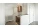 Hallway with built-in desk area, overhead cabinet and doors leading to other rooms at 5303 N 7Th St # 101, Phoenix, AZ 85014