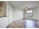 Bright living room with tile floors, ceiling fan, and large window providing natural light at 5303 N 7Th St # 101, Phoenix, AZ 85014
