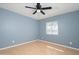 Cozy bedroom featuring a ceiling fan, window, and soft natural light at 562 W Keats Ave, Mesa, AZ 85210