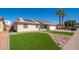 Inviting single-Gathering home with an expansive green lawn, desert-style landscaping, and a two-car garage at 562 W Keats Ave, Mesa, AZ 85210