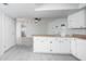 Open kitchen with white cabinets, wood countertops, gray tile floors, and stainless steel appliances at 562 W Keats Ave, Mesa, AZ 85210