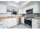 Bright kitchen with stainless steel appliances, light wood counters, and a stylish blue backsplash at 562 W Keats Ave, Mesa, AZ 85210