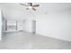 Airy living room with gray tile floors, a ceiling fan, neutral walls, and lots of natural light at 562 W Keats Ave, Mesa, AZ 85210
