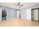 Spacious bedroom with hard wood floors, a ceiling fan, a walk-in closet and an attached bathroom at 562 W Keats Ave, Mesa, AZ 85210