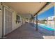 The patio is covered, with lighting, a mounted TV and a bar for entertaining by the beautiful pool at 562 W Keats Ave, Mesa, AZ 85210