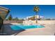 Relax in the backyard's beautiful pool area, complete with a basketball hoop, palm tree and ample space for recreation at 562 W Keats Ave, Mesa, AZ 85210