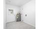 Clean utility room with modern water heater, tiled floor and a door to the backyard at 562 W Keats Ave, Mesa, AZ 85210