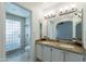 Bathroom featuring a double sink vanity with granite countertops and glass block shower at 6223 N 12Th St # 8, Phoenix, AZ 85014