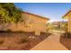 Well-maintained home exterior with rock landscaping, gated entrance, and charming window details in a quiet setting at 6223 N 12Th St # 8, Phoenix, AZ 85014
