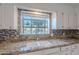 Kitchen sink featuring granite countertops, mosaic tile backsplash, and a backyard view at 6223 N 12Th St # 8, Phoenix, AZ 85014