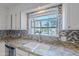 Kitchen sink featuring granite countertops, mosaic tile backsplash, and a window with a pool view at 6223 N 12Th St # 8, Phoenix, AZ 85014