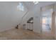 Living room featuring travertine flooring, bar, and staircase leading to the second floor at 6223 N 12Th St # 8, Phoenix, AZ 85014
