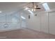 Spacious loft area with neutral carpet, a ceiling fan, and vaulted ceilings with skylights at 6223 N 12Th St # 8, Phoenix, AZ 85014