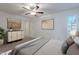 Bright bedroom featuring a ceiling fan and large windows with shutters at 6223 N 12Th St # 8, Phoenix, AZ 85014