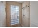 Shower featuring glass block window and travertine tile at 6223 N 12Th St # 8, Phoenix, AZ 85014
