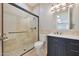Elegant bathroom featuring tiled shower with glass door, modern vanity with marble countertop, and stylish fixtures at 6615 E Shea Blvd, Scottsdale, AZ 85254
