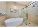 Modern bathroom with a freestanding tub and a separate glass-enclosed shower at 6615 E Shea Blvd, Scottsdale, AZ 85254